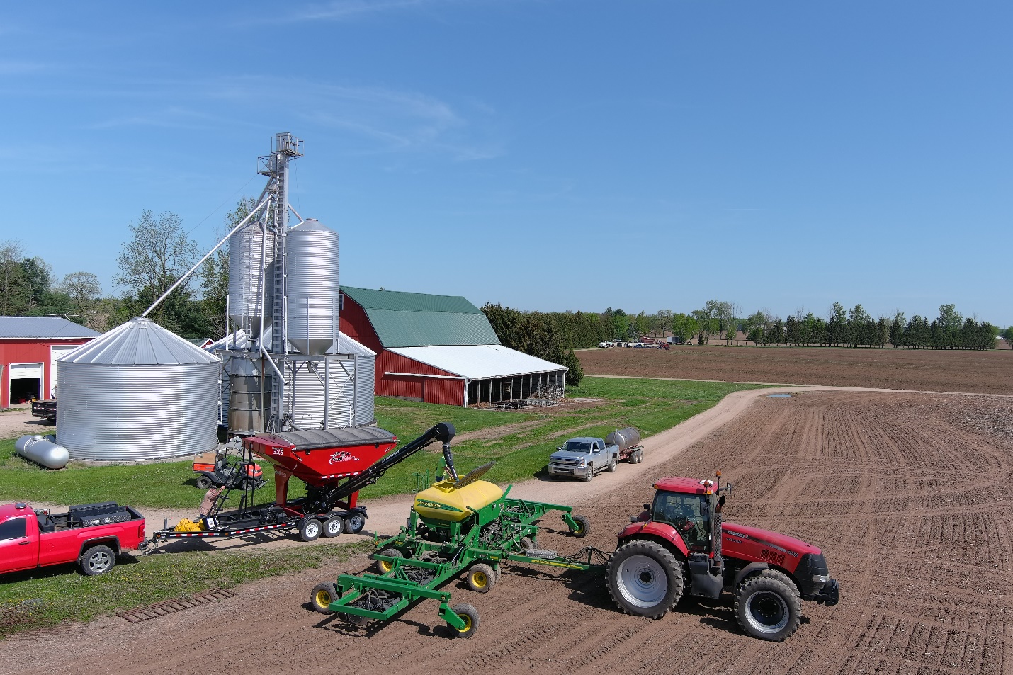 Tractors and trucks on a farm.